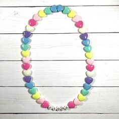 "You have just found the perfect gift for birthdays or Easter! This cute pastel, retro HEART necklace can come personalized or with hearts only. This 16\" stretchy necklace fits right over your head so it's easy to put on- no clasps needed. The matching bracelet is listed here: https://www.etsy.com/listing/909362079/kids-heart-bracelet-party-favor-girls?ref=shop_home_active_5&frs=1 Please check all selections and spelling prior to check out. Our custom jewelry is made to order so all sales a White Heart Necklace With Charm For Birthday, Pink Heart Necklace For Birthday And Mother's Day, White Heart Necklace For Birthday And Valentine's Day, Playful Heart Beads Necklace For Gift, Personalized Playful White Necklace, Playful Heart Beads Necklace As Gift, Fun Pink Necklace For Birthday, Playful Personalized White Necklace, White Heart Charm Necklace For Birthday