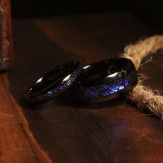 two black rings sitting on top of a wooden table