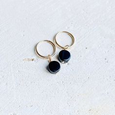 Dainty 14k Gold Filled Endless hoop earrings with Black Onyx coin charm Size - 14mm hoops with a 6-7 mm Black Onyx charm - B L A C K   O N Y X -  Helps with : Grounding, Protection, willpower, focus, and strength - C H A K R A - Root - GOLD FILLED -    Gold-filled jewelry is composed of a solid layer of gold mechanically bonded to a base of either sterling silver or some base metal. Gold Filled is much more affordable than solid gold, but with the same beautiful color and shine. It is more durable than plated metals because the gold content is significantly thicker. - CARE & CLEANING -  Here are some tips to keep your jewelry in great shape for many years: > Jewelry should be put on after products like lotion, perfume, and hairspray  > Do not wear jewelry to swim or shower > To clean, wash Nickel-free Black Huggie Jewelry, Nickel Free 14k Gold Filled Huggie Earrings, Black Nickel-free Huggie Jewelry, Handmade 14k Gold Round Huggie Earrings, 14k Gold Filled Round Huggie Earrings, 14k Gold Filled Round Huggie Earrings With Ear Wire, Black Round Huggie Earrings For Everyday, Biwa Pearls, Black Onyx Earrings