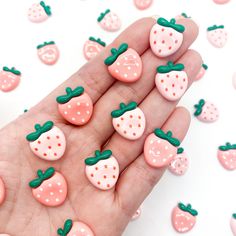 someone is holding some fake strawberries in their hand and it looks like they are made out of polymer