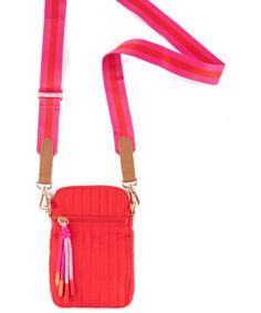 a small red purse with pink straps and a tassell on the strap is shown