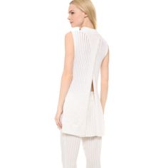 Thakoon White Floating Rib Knit Wool Tunic Sz S New Without Tags, Never Worn. Thakoon Puts An Elegant Spin On A Sleeveless Mock-Neck Top, Crafting This Retro Classic In Ribbed Knit With Delicate Shadow Stripes. A Split Back Panel And High Side Slits Add An Airy, Alluring Element. Semi-Sheer. Fabric: Delicate Ribbed Knit. 51% Wool/49% Cotton. Hand Wash Or Dry Clean. Color: White Approx. Measurments: Arm Pit To Arm Pit: 19" Total Length : 31.5" Chic Textured Knit Daywear Tops, Chic Knit Top For Daywear, Chic Textured Knit Tops For Daywear, White Spring Knit Top For Loungewear, White Sleeveless Pointelle Knit Sweater, Sheer Shorts, White Caps, Cotton Long Sleeve Shirt, Floral Tunic