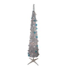 a white christmas tree with blue and silver ornaments on it's base, against a white background