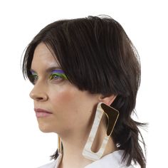 A native of Belgium, Véronique Leroy moved to Paris in the early eighties where she began her fashion design career at Studio Berçot, leaving to assist Didier Renard three years later. Leroy established her own label in 1991 having previously worked for Azzedine Alaia and Martine Sitbon. Oversized rectangular earrings with a gold and marble tone finish. Approx. 4.3" Material: 100% AcetateColor: Marble chalk gold Made in France Modern Lucite Earrings, Modern Handmade Clip-on Earrings, Modern White Clip-on Earrings, Martine Sitbon, Career In Fashion Designing, Color Marble, Rectangular Earrings, Azzedine Alaia, Moving To Paris