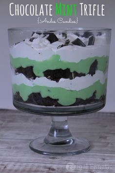 a green and white layered cake in a glass dish with the words chocolate mint trifle on it