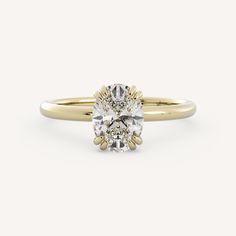 a yellow gold engagement ring with an oval cut diamond