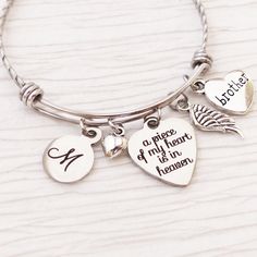 "Remembrance bangle bracelet. Memory remembrance jewelry. This bangle bracelet includes an a piece of my heart is in heaven charm. It also includes a brother (or daughter, grandma, etc) heart charm, wing charm, small heart and 1 round letter charm.  I do have different \"saying\" charms that can be swapped out for the \"a piece of my heart is in heaven\" charm, if indicated at checkout. Otherwise it will remain as the first image shows. I have included other samples in the listing of other optio Silver Bracelets Keepsake For Mother's Day, Engraved Silver Bracelet For Memorial, Memorial Engraved Silver Bracelets, Silver Engraved Bracelet For Memorials, Adjustable Bracelet For Mother's Day Keepsake, Silver Engraved Bracelet For Memorial, Personalized Round Bracelets For Keepsake, Adjustable Hand Stamped Jewelry For Memorial, Engraved Jewelry For Mother's Day Remembrance