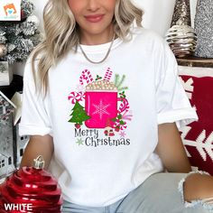 Introducing our Cozy Christmas Gnome Mug T-Shirt, the perfect festive addition to your holiday wardrobe! This Merry Christmas Tee features a charming holiday gnome enjoying a warm cup of hot chocolate, making it the ideal choice for spreading Christmas cheer. Crafted on a soft and comfy Comfort Colors shirt, this Christmas Graphic Tee is not only adorable but also incredibly cozy. Get ready to snuggle up in style this season with our Holiday Hot Chocolate Shirt! Warm Gnome Tee, Cozy Holiday Mug, White Crew Neck T-shirt For Christmas, White Christmas T-shirt Gift, White Christmas Festive T-shirt, Festive White Crew Neck T-shirt, Festive White T-shirt With Letter Print, White Crew Neck T-shirt For Festive Occasions, Chocolate Shirt, Merry And Bright Shirt, Holiday Hot Chocolate