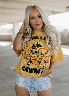 Long Live Cowboys Skull OVERSIZED 80's throwback distressed Cropped T- shirt available in faded mustard This Crop Jersey Tee slides right into streetwear style for Summer and Winter.. With oversized sleeves and a relaxed body, this on-trend tee drops a little lower in the back for an effortlessly cool feel. Fabricated from ultra-soft, lightweight Airlume cotton that's fit to flatter, this looser crop features a finished hem and neck binding.Features: Finished hem. Oversized sleeves. Neck binding Trendy Acid Wash Tops For Fall, Oversized Graphic Print Cropped T-shirt For Streetwear, Trendy Acid Wash T-shirt For Fall, Oversized Hip Hop Tops For Halloween, Distressed Edgy Tops For Fall, Edgy Washed Tops For Fall, Edgy Cropped T-shirt For Spring Streetwear, Skull Print Tops For Spring Streetwear, Fall Distressed Tops For Streetwear