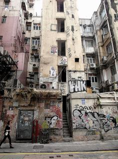 an old building with graffiti all over it's walls and stairs leading up to the top floor