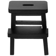 a black wooden stool with a hole in the top and bottom section on an isolated white background