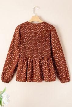 This Rust Mini Floral Smocked Bust Ruffled Peplum Blouse is designed for both style and comfort. The smocked bust and ruffled peplum add a playful touch to the classic rust color and mini floral pattern. With its flattering fit and unique design, this blouse is perfect for any occasion. Size Chart (INCH) Sizes Bust Shoulder Sleeve_Length Length Hem_Width Relax Relax Relax Relax Relax S 28.3 13.4 24.4 24.8 60.6 M 30.7 14.0 24.8 25.6 63.0 L 33.1 14.6 25.2 26.4 65.4 XL 36.2 15.4 25.6 27.2 68.5 Elas Peplum Design, Peplum Designs, Feminine Elegance, Hourglass Silhouette, Drape Sleeves, Peplum Blouse, Floral Pants, Blouse Online, Romper With Skirt