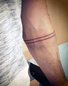 a man's arm with a small tattoo on the left side of his leg