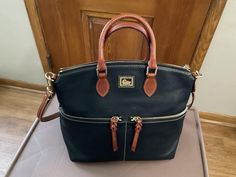 Pebble Grain Leather  A zipper closure Adjustable detachable shoulder strap 11.5" drop length Handle drop length 4" H 10.5"x W 6" x L 12" Weighs 1lbs 14oz two outside pockets,inside zipper pocket,3 slip pockets,has feet,and key leash Charleston Wv, Dooney And Bourke, Dooney & Bourke, 4 H, Purses And Handbags, Inside Pocket, Zipper Pocket, Shoulder Bags, Satchel