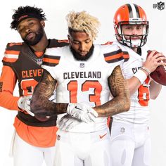 two cleveland browns football players standing next to each other with their arms around one another