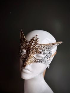 This women's silver and gold lace masquerade mask, a masterpiece of lace in silver and gold, is your key to a night of enchantment and timeless allure. Delicate lace forms the shape of a fox, symbolizing your cleverness. Whether you're attending a grand masquerade ball, a woodland-themed event, or simply looking to make a dramatic entrance, this mask ensures you'll be the center of attention.


Age Group/Gender - Adult/Women

Size/Type - One size fits all adults

Mask Color - Silver/Gold

Mask M Masquerade Mask Aesthetic, Fox Masquerade Mask, Masquerade Mask Lace, Lace Masquerade Mask, Masquerade Mask Women, Couples Masquerade Masks, Lace Masquerade Masks, King Costume, Venetian Masquerade Masks