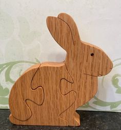 a wooden toy rabbit sitting on top of a table