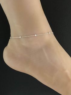 925 Sterling Silver Rhodium Plated Beaded Ankle BraceletANKLET FEATURES:Metal:  All components are made from solid .925 Sterling Silver Rhodium Plated Model is wearing 9" in length  solid .925 Sterling Silver Bead ChainChain Length:  9 inchYour Dainty Rolo Beaded Anklet will arrive in a gift box, beautifully wrapped and ready for giftingPlease send me a message if you have any questions before or after placing your order. Please also view my policy before purchasing. **************************** Silver Minimalist Anklets For Party, Elegant Beaded Chain Anklets, Elegant Adjustable Anklets With Silver Beads, Delicate Silver Jewelry For Summer, Delicate Silver Summer Jewelry, Elegant Adjustable Anklet With Tiny Beads, Delicate Adjustable Silver Anklets, Silver Beaded Anklets For Summer, Elegant Adjustable Sterling Silver Anklets