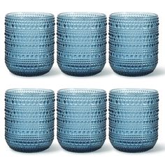 six blue glass cups are lined up together