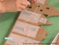 someone is making a christmas tree out of cardboard and stringing it up with scissors