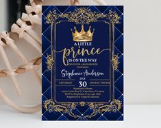 a little prince is on the way blue and gold birthday party card with a crown