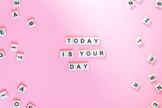 the word today is your day spelled with scrabbles on pink paper background