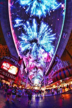 fireworks are lit up in the sky above a shopping mall