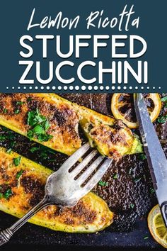 lemon ricotta stuffed zucchini on a baking sheet with a knife and fork