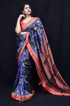 Weaver communities of Maniabandha and Nuapatana of Odisha traditionally weave this kind of saree. Common motifs are star, temple, conch, rudraksh, fish, chakra, lotus etc. The inspiration of all its designs comes from nature. It is the best of single ikat; one of warp and weft is tied and dyed prior to weaving. The borders and the pallas have tremendous variety and each one of them is attractive and praiseworthy. Specification:  Occasion: Festive Wear Fabric: Mulberry Silk,  Primary Color:Blue Secondary Color:Red Material : Mulberry Silk Pattern: Motif Border Type: Ikkat Border Size: Medium Blouse Piece: Included Care: Dry Clean Disclaimer : This is a genuine handwoven piece, & that could expect unevenness in the selvedge and weave, and colours may fade or bleed due to the traditional dyei Multicolor Motif Pre-draped Saree For Puja, Multicolor Ikat Print Pre-draped Saree For Navratri, Multicolor Pre-draped Saree With Motifs For Puja, Traditional Ikat Print Pre-draped Saree For Festivals, Traditional Multicolor Pre-draped Saree For Navratri, Festive Ikat Print Saree With Traditional Drape, Traditional Ikat Print Wear For Diwali Ceremonies, Ikat Print Traditional Wear For Diwali, Traditional Wear With Ikat Print For Diwali