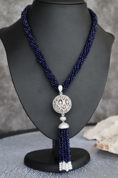 🔥Type: Necklace 🔥Total Weight: 81.74 Grams 🔥Necklace Length: 560mm  🔥Finish: Rhodium Plated Silver Finish 🔥Elements include: Zero size imitation pearls Glass Beads Cubic Zirconia 🔥Size of main element: 3.12mm x 3.12mm x 135mm 🔥Colour Palette: Blue and White 🔥Please note: All the pieces in store are BRASS AND COPPER based No lead or nickel or zinc 🔥Care tips: Store in airtight bags (provided) Like all jewellery it should be the last thing you put on and the first thing you take off Handl Luxury Silver Pendant Lariat Necklace, Formal Round Necklace With Polished Beads, Formal Round Polished Beads Necklace, Elegant Necklace With Sterling Silver Clasp And Round Pendant, Elegant Necklace With Sterling Silver Round Pendant, Silver Pendant Lariat Necklace For Formal Occasions, Elegant Long Gemstone Chain Necklace, Elegant Blue Chain Necklace, Silver Dangle Necklaces With Polished Beads