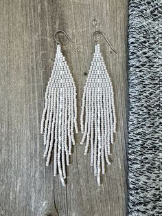 Earrings: Handmade beaded fringe earrings. Color and design: Matte gray and white colors in a stitched stripe design.   Hooks: High quality hypoallergenic titanium commercial pure grade 1 ear wires (feels so comfortable for even the most sensitive skin).  Beads: High quality 11/0 miyuki seed beads. Size: 1" width x 4.5" drop. White Beaded Fringe Long Drop Earrings, White Long Drop Beaded Fringe Earrings, White Long Drop Jewelry With Beaded Fringe, Adjustable White Beaded Earrings With Silver Beads, White Bohemian Beaded Earrings With Silver Beads, Bohemian White Beaded Earrings With Silver Beads, White Silver Beaded Drop Earrings, White Dangle Beaded Earrings With Tassels, Adjustable White Beaded Tassel Earrings