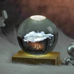 a snow globe sitting on top of a wooden block next to a small toy figure