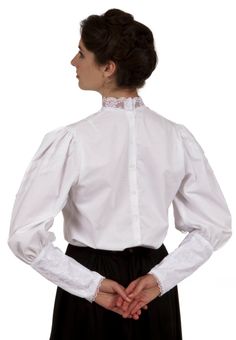 Perfect for an evening dinner with family and friends, this Victorian styled blouse will put you on the receiving end of numerous compliments! Charming cotton blouse has a cascading lacy jabot in front. The collar is trimmed in lace as well as the lace covered sleeves. Blouse has back button closure. Hand wash or machine wash gently. Tumble dry low or hang dry. 100% cotton. Poly lace trim. Koryn is wearing a skirt and brooch which are priced separately. Designed and made proudly by Recollections Elegant Ruffled Lace Top, Victorian Cotton Fitted Blouse, Fitted Victorian Cotton Blouse, Feminine Formal Tops With Lace Cuffs, Fitted Blouse With Lace Trim For Workwear, Elegant Cotton Lace Top With Ruffles, Cotton Lace Top With Ruffles, Fitted Victorian Tops With Lace Collar, Elegant Cotton Tops For Wedding