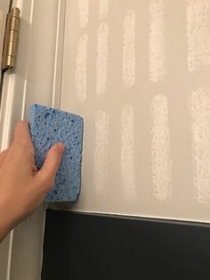 someone is using a sponge to clean the door