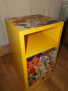 a yellow cabinet with flowers painted on it