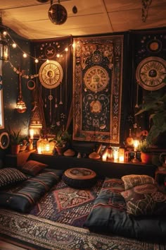 a bed with lots of pillows on top of it and some lights hanging from the ceiling