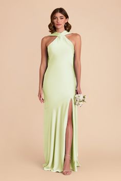 a woman in a lime green dress with a slited skirt and high neckline