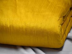 Honey Yellow Pure Dupioni Fabric Raw Silk by the Yard Indian Wedding Dresses Pillow Cover Drapery Blouses Curtains Cushions Costume sewing  ➤Color:  Honey Yellow  ➤Quality: The fabric is 100% dupioni silk of the highest grade. (100gsm) ➤Width: 44 inches ➤Code: sf171 ➤Listing for 1 Yard of fabric Honey Yellow silk or raw silk fabric, made from pure silk yarn. This is a very beautiful tone-on-tone Honey Yellow. Indian dupioni silk or raw silk fabric, made from pure silk yarn. 100% pure silk fabric has been made in India. This dupioni is perfect for bridal & bridesmaids dresses, drapery, quilting, pillows, & chair upholstery, Dresses, Tops, Blouses, Jackets, Crafting, Clutches or Evening Bags, Embellish your clothes, Home Décor, Outdoor, Quilting, Sewing, General etc use it for scrap booking Blue Green Walls, Wedding Dress Costume, Super Chunky Knit, Costume Sewing, Raw Fabric, Wallpaper Ceiling, Raw Silk Fabric, Honey Yellow, Indian Wedding Dresses