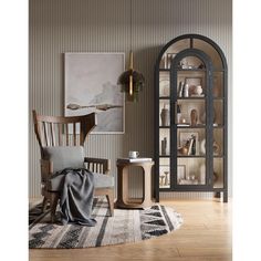 a living room filled with furniture and a tall book shelf next to a chair on top of a rug