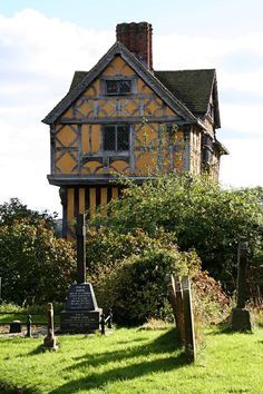 an old house with a clock tower in the middle of it's lawn area