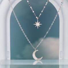 Indulge in the mesmerizing beauty of our double layer celestial pendant necklace, crafted with utmost care from luxurious 925 sterling silver and adorned with sparkling cubic zirconia pave. This exquisite piece features a shorter choker length necklace with a dazzling star charm and a longer crescent moon necklace. Elevate your jewelry collection with this delicate yet captivating moon and star necklace, perfect for everyday wear or as a heartfelt gift for your loved ones. Materials: 925 sterlin Celestial Style White Gold Necklace With Cubic Zirconia, Celestial Cubic Zirconia Pendant Necklace, Celestial Silver Diamond Necklace Gift, Celestial Style Silver Diamond Necklace Gift, Moon And Star Necklace, Celestial Pendant, Mesmerizing Beauty, Star Pendant Necklace, Length Necklace