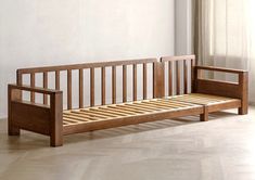 a wooden bed frame sitting on top of a hard wood floor next to a window