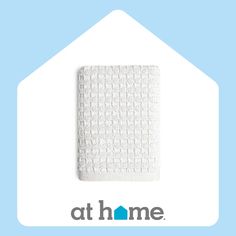 the logo for at home is shown in front of a white house and blue background