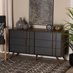 a living room with a black and white rug, brown furniture and a painting on the wall