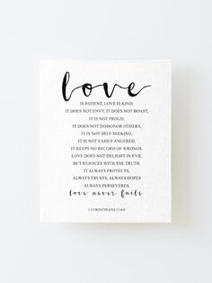 a card with the words love written in black ink on it and a white background