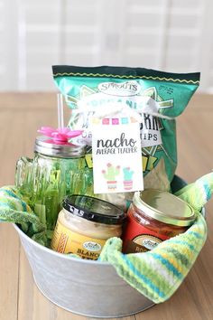 a bucket filled with lots of food sitting on top of a wooden table