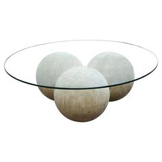 three white balls sitting on top of a glass table