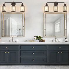 a bathroom with two sinks and mirrors on the wall