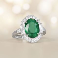 This item has just been reserved by another customer. Please contact us to be notified if it becomes available.  This stunning ring showcases a magnificent oval-cut emerald weighing approx 3.71 carats as its center, delicately held in place by prongs. The emerald is beautifully encircled by a halo of diamonds. On either side of the center stone and along the ring's shoulders, baguette-cut diamonds are accented. The total diamond weight of this ring is approximately 0.60 carats. The platinum sett Green Oval Emerald Ring In Platinum, Luxury Oval Emerald Birthstone Ring, Art Deco Oval Emerald Ring With Brilliant Cut, Heirloom Oval Emerald Ring, Classic Oval Tsavorite Ring, White Gold Oval Emerald Ring Art Deco Style, Timeless Oval Emerald Ring For Formal Occasions, Exquisite Oval Emerald Ring In Platinum, Exquisite Oval Emerald Ring