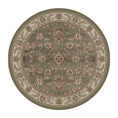 a round rug with an ornate design on the center and bottom, in green tones